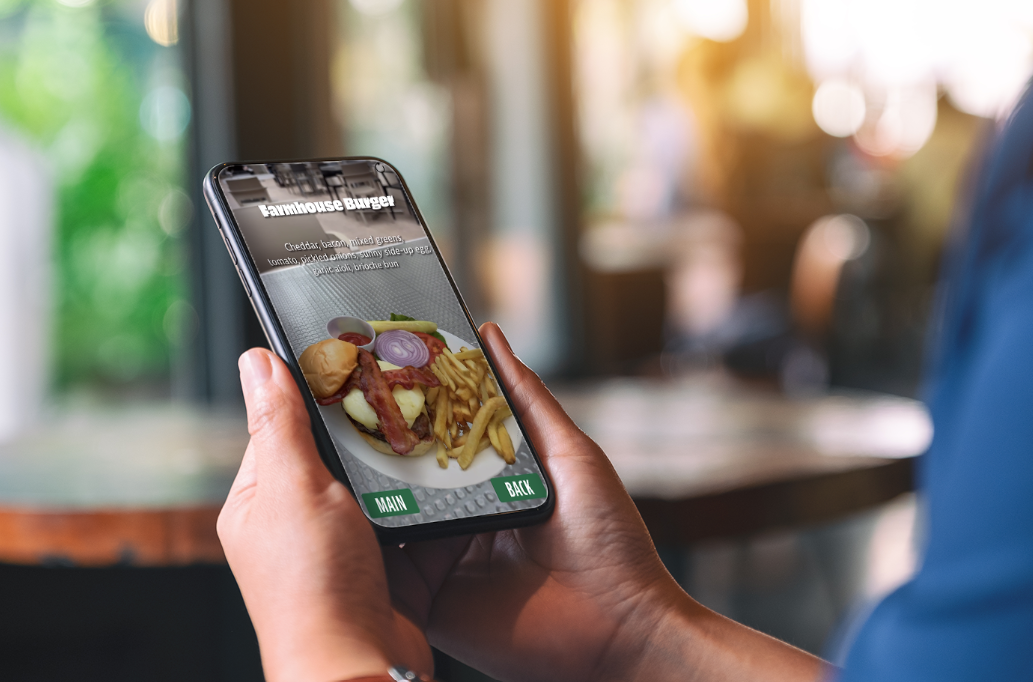 Person using AR menu on smartphone in restaurant